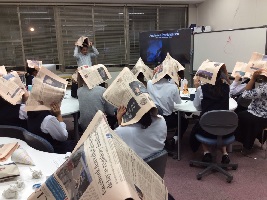 Participants wore newspapers during the rainstorm scene.